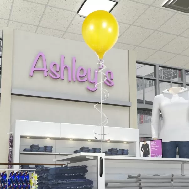 Yellow PermaShine balloon on a magnetic bracket in a clothing display