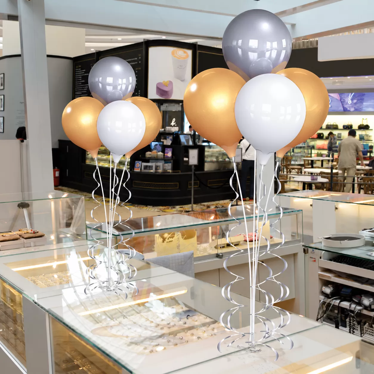 Silver, gold and white PermaShine four-balloon bouquets on adhesive tabletop mounts