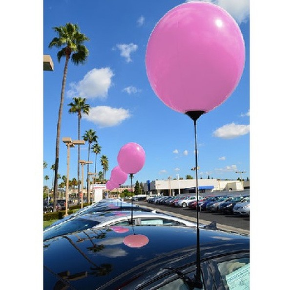 Pink reusable balloon with holder pole and removable vehicle window clip