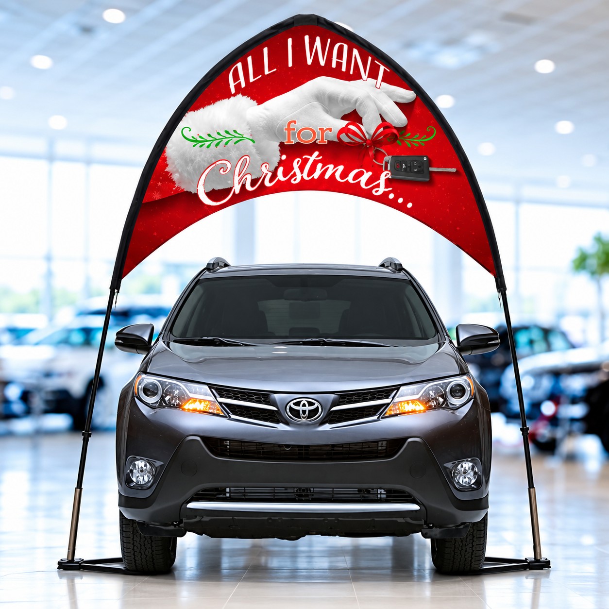 All I Want for Christmas arch banner with poles and tire bases around a display vehicle