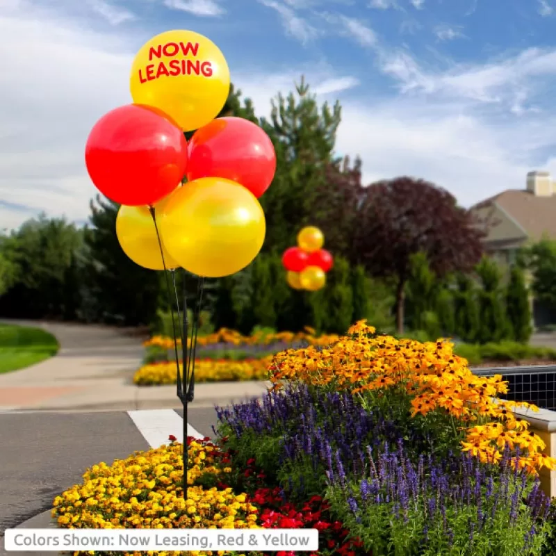 Now Leasing yellow balloon with red and yellow DuraBalloons in a five-balloon cluster