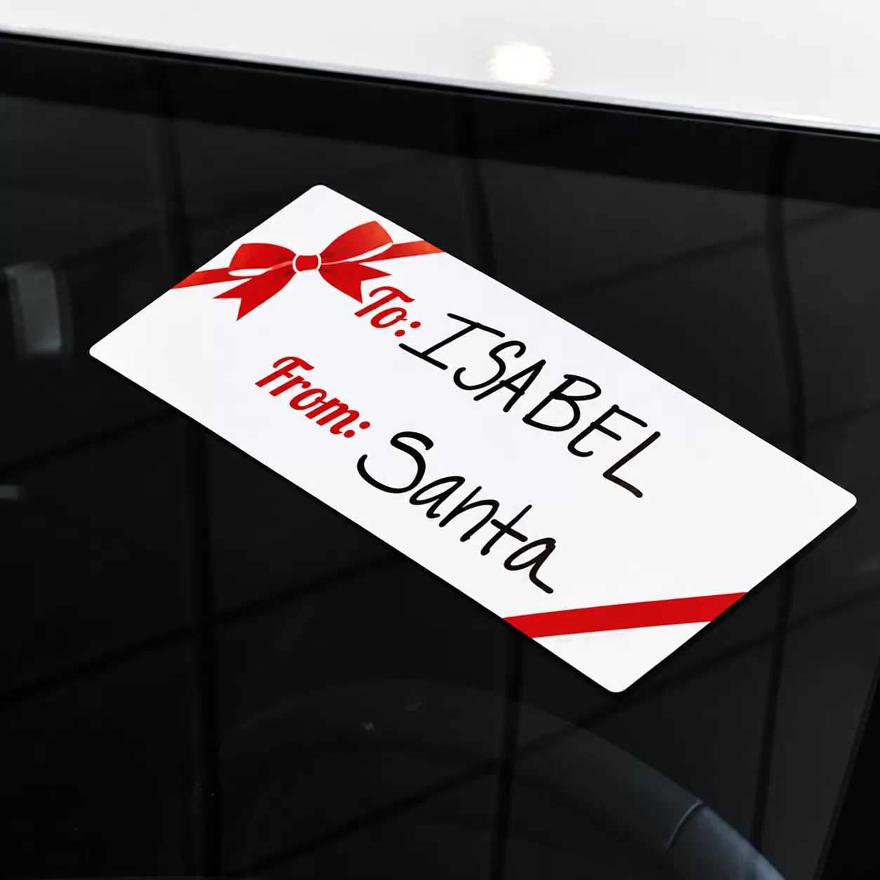 White holiday windshield gift tag decal with red bow and To and From fields