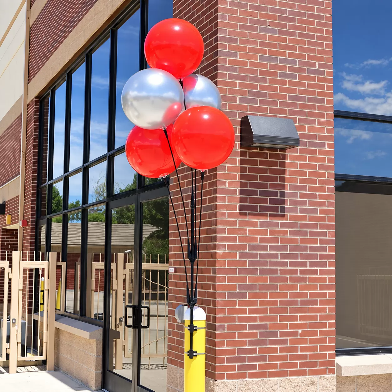 Five red and silver DuraBalloons on a cluster pole banded to a bollard