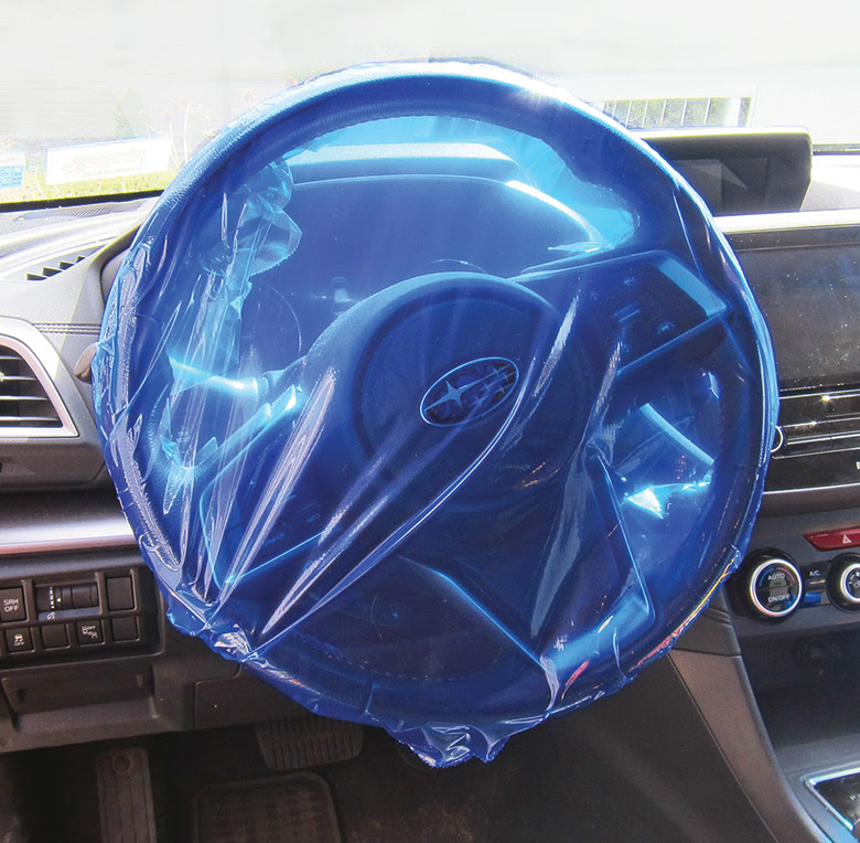Blue adhesive protection film fitted over a steering wheel, model 1107