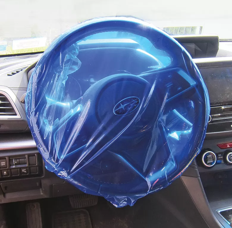 Blue adhesive protection film fitted over a steering wheel, model 1107