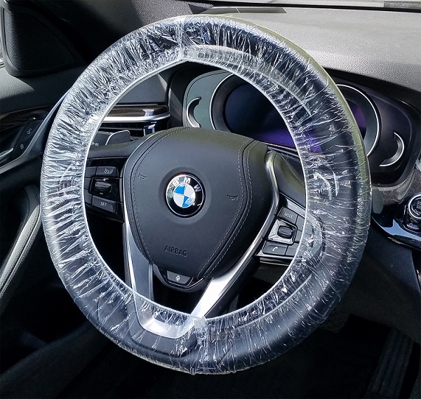 Disposable double-elastic plastic steering wheel covers for wheels up to 24 inches